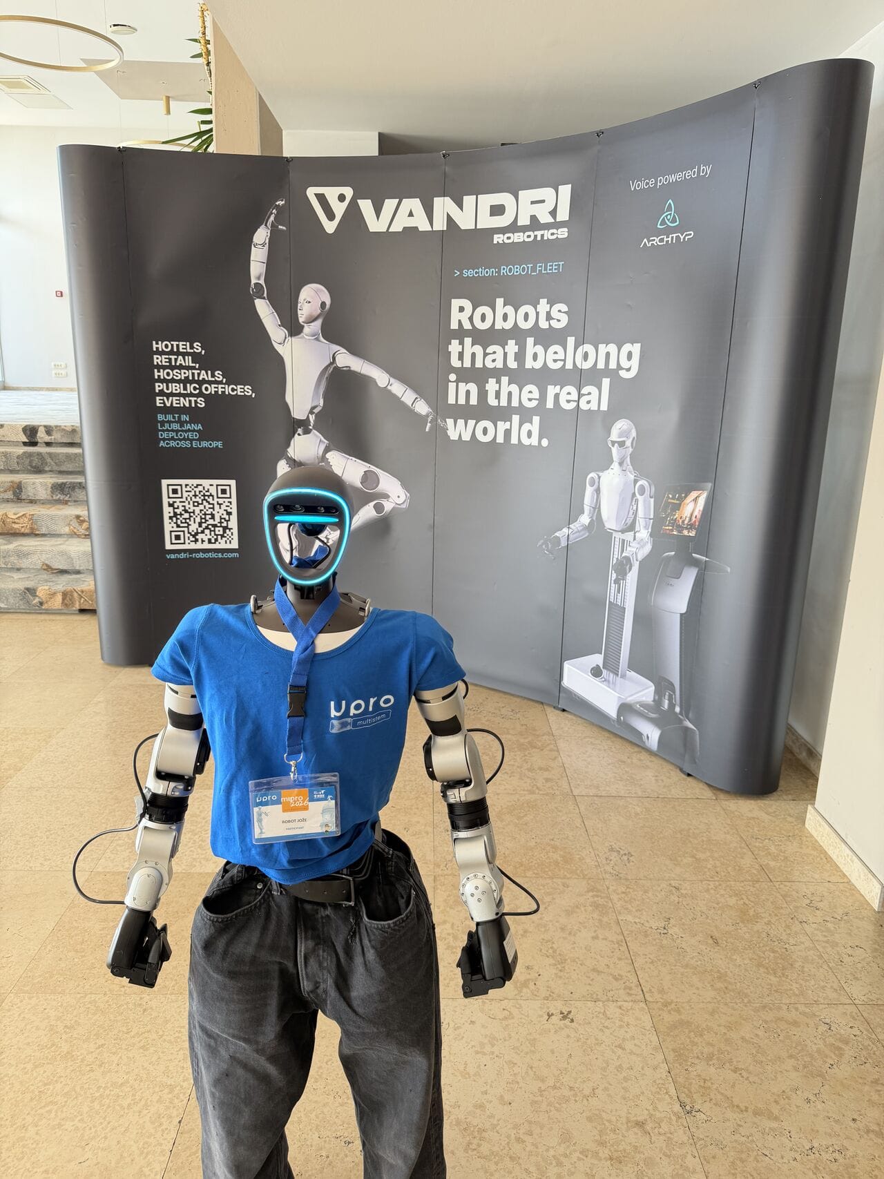 Humanoid robot Jože at the Vandri Robotics branded wall at MIPRO 2026
