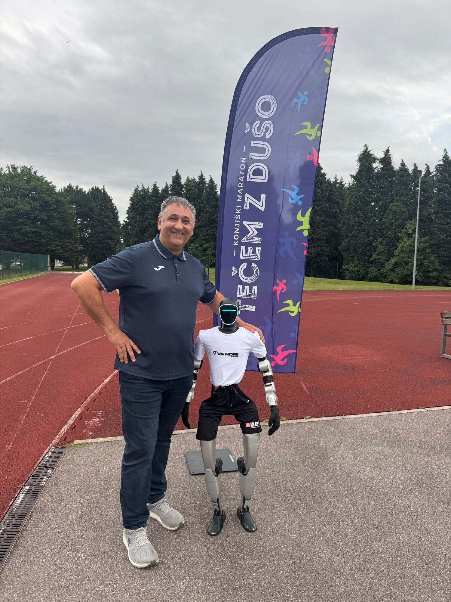 Humanoid robot Jože with his coach at the athletics track in Slovenske Konjice