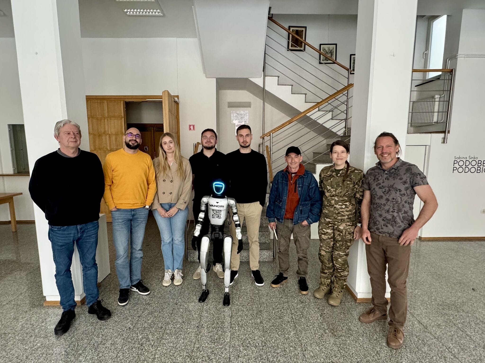 Cast of the play with the humanoid robot before the performance